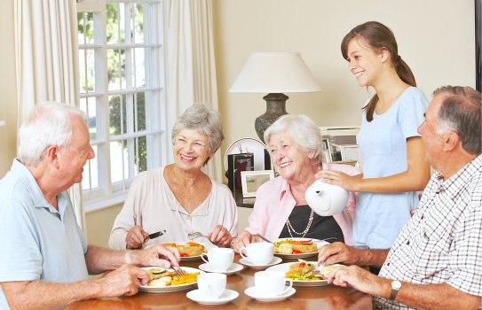 seniors serving foods by a caregiver