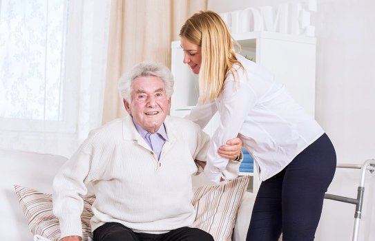 senior man assisted by a caregiver