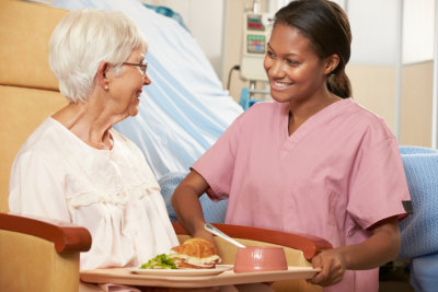 caregiver preparing food for her patient