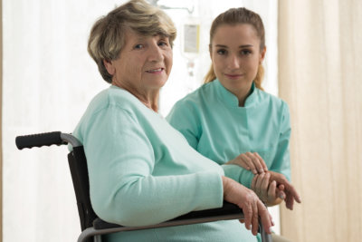 caregiver and senior woman smiling